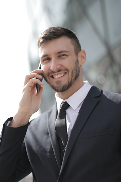 Professional man on the phone, smiling and happy