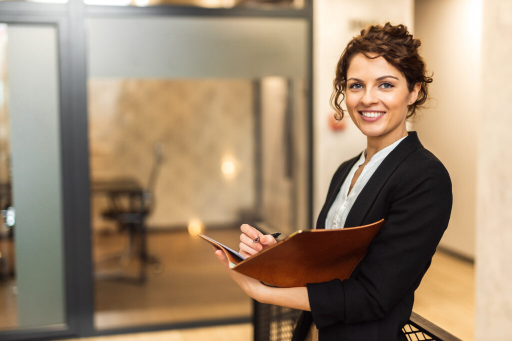 Portrait of a positive young business woman smiling at the camera